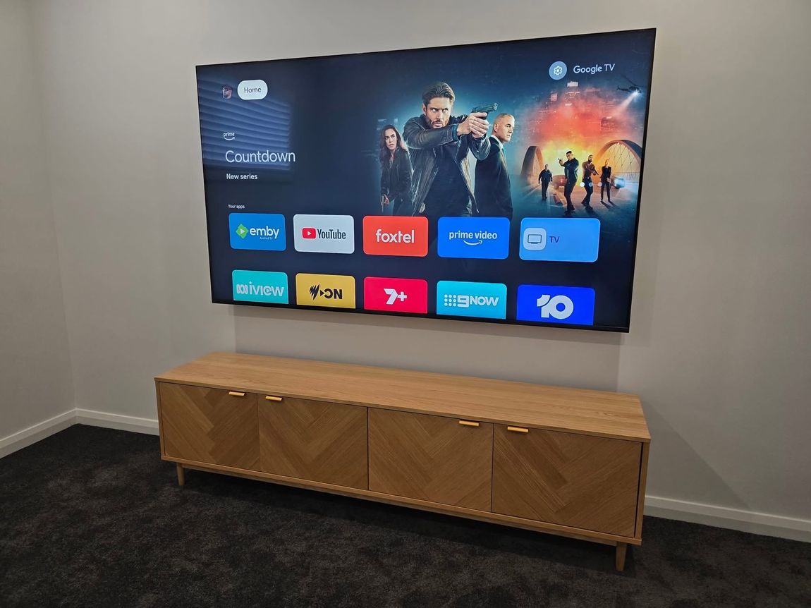 Wall-mounted TV set up with streaming apps